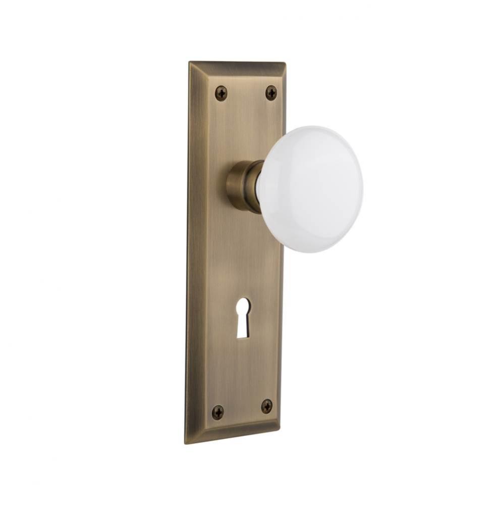 Nostalgic Warehouse New York Plate with Keyhole Privacy White Porcelain Door Knob in Antique Brass