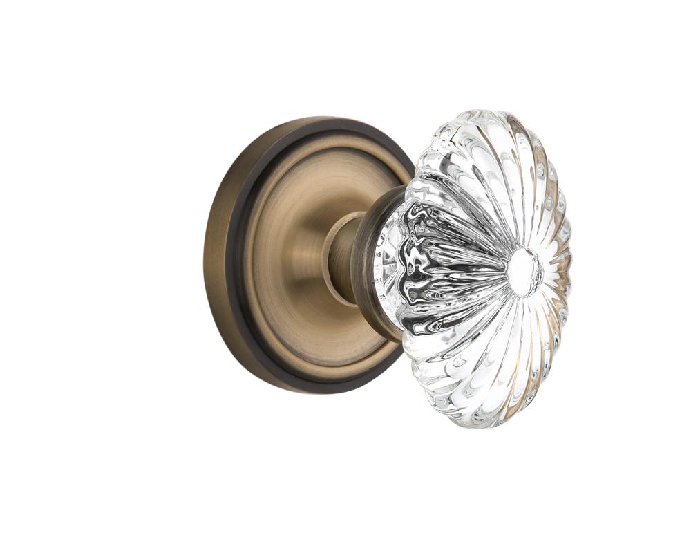 Nostalgic Warehouse Classic Rosette Passage Oval Fluted Crystal Glass Door Knob in Antique Brass