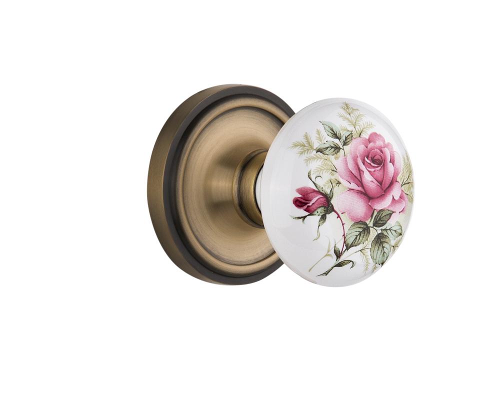 Nostalgic Warehouse Classic Rosette Passage White Rose Porcelain Door Knob in Antique Brass