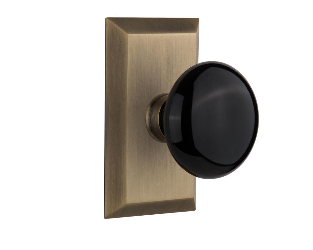 Nostalgic Warehouse Studio Plate Passage Black Porcelain Door Knob in Antique Brass