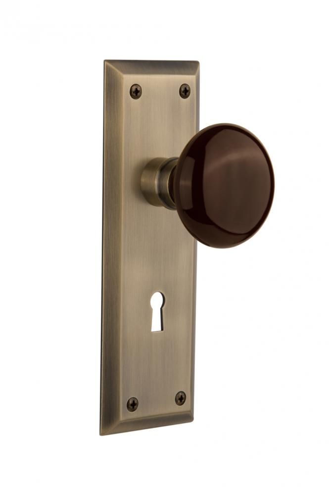 Nostalgic Warehouse New York Plate with Keyhole Privacy Brown Porcelain Door Knob in Antique Brass