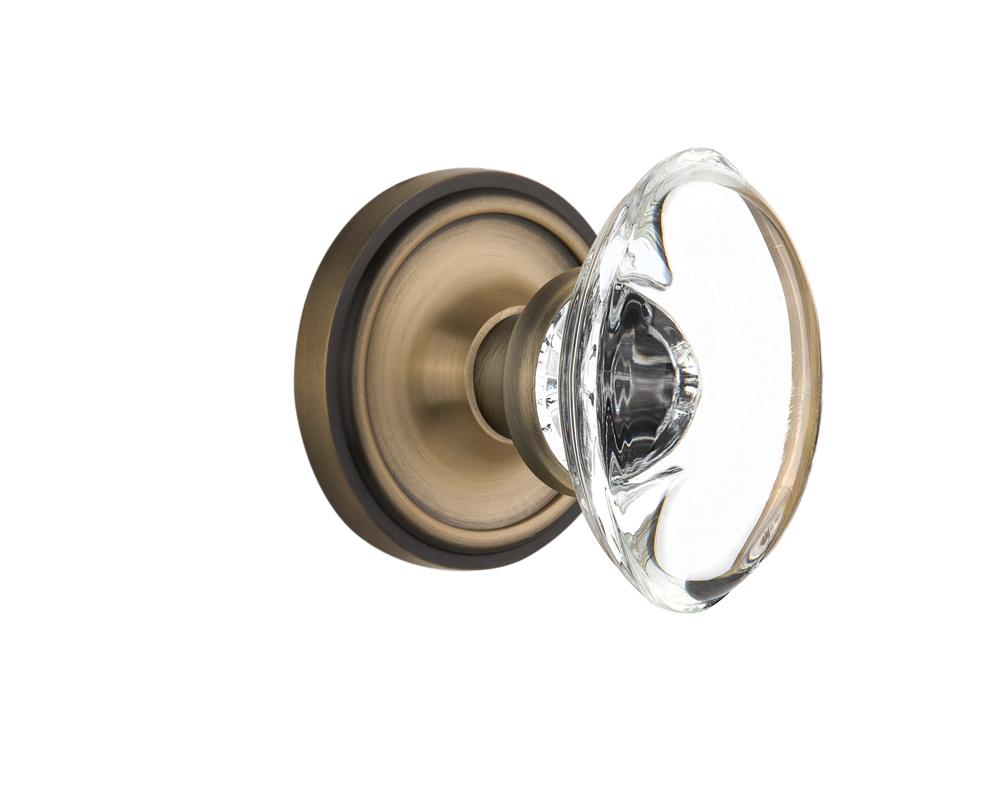 Nostalgic Warehouse Classic Rosette Passage Oval Clear Crystal Glass Door Knob in Antique Brass